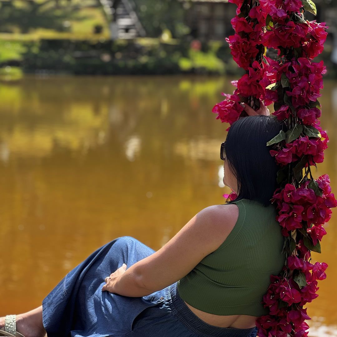 Pessoa sentada em frente ao lago relaxando